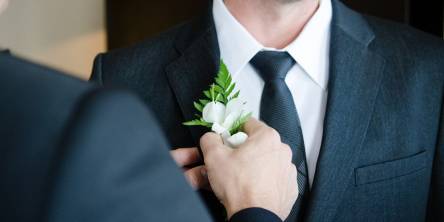 Groom being given flower
